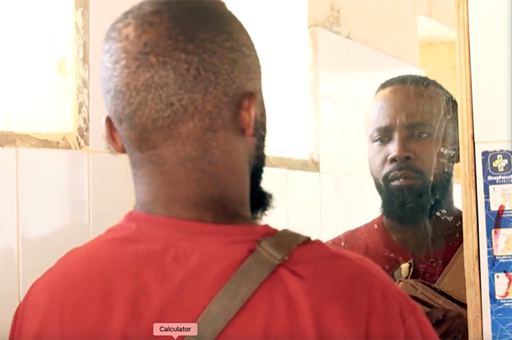 Image of African man looking into mirror.; The Bridge&nbsp;Hybrid Screening and Discussion