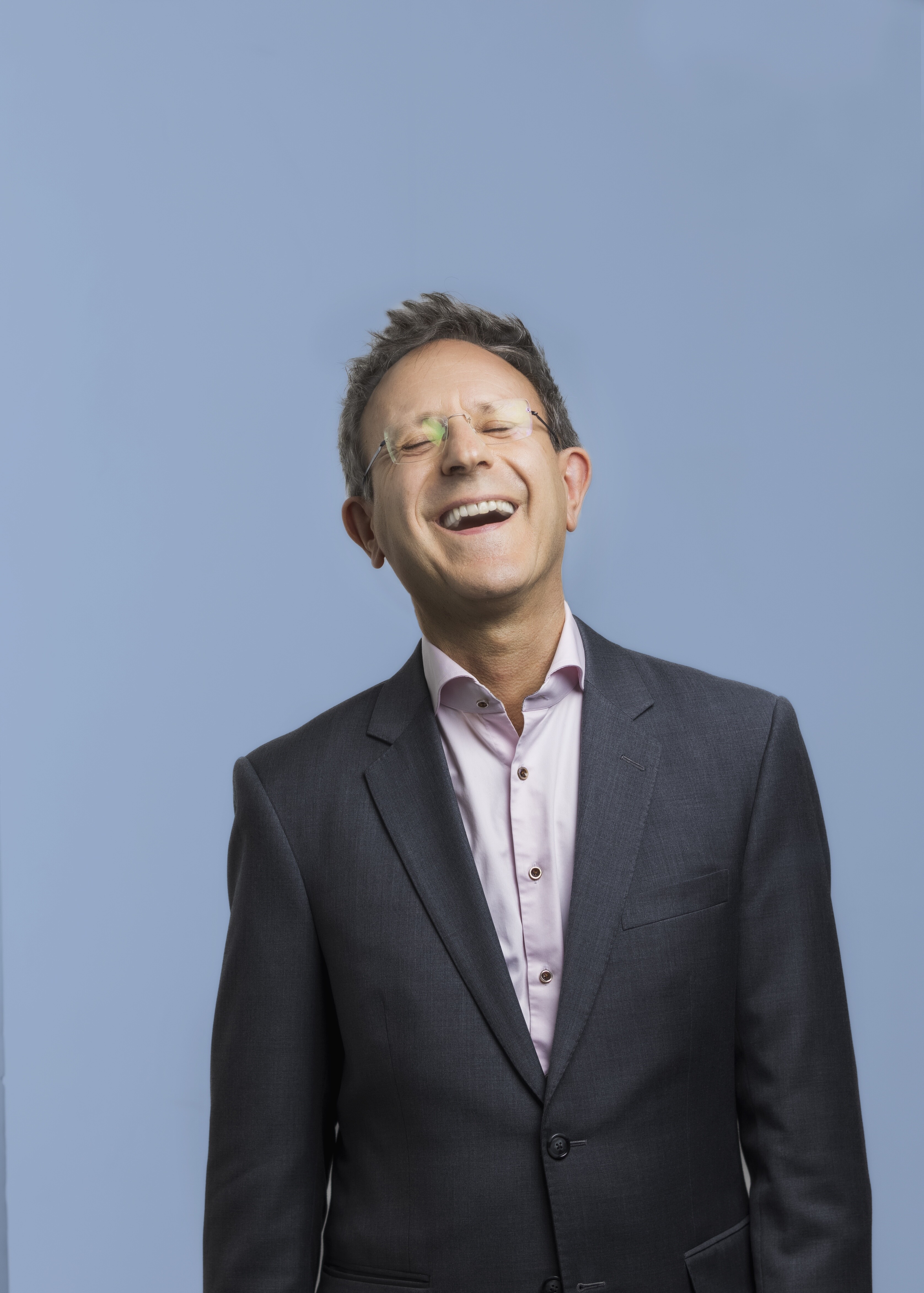 Pierre Vallet smiling with his head tilted back and eyes closed, with a blue background.; Vocal Arts Residency: M&eacute;lodies Masterclass with&nbsp;Pierre Vallet