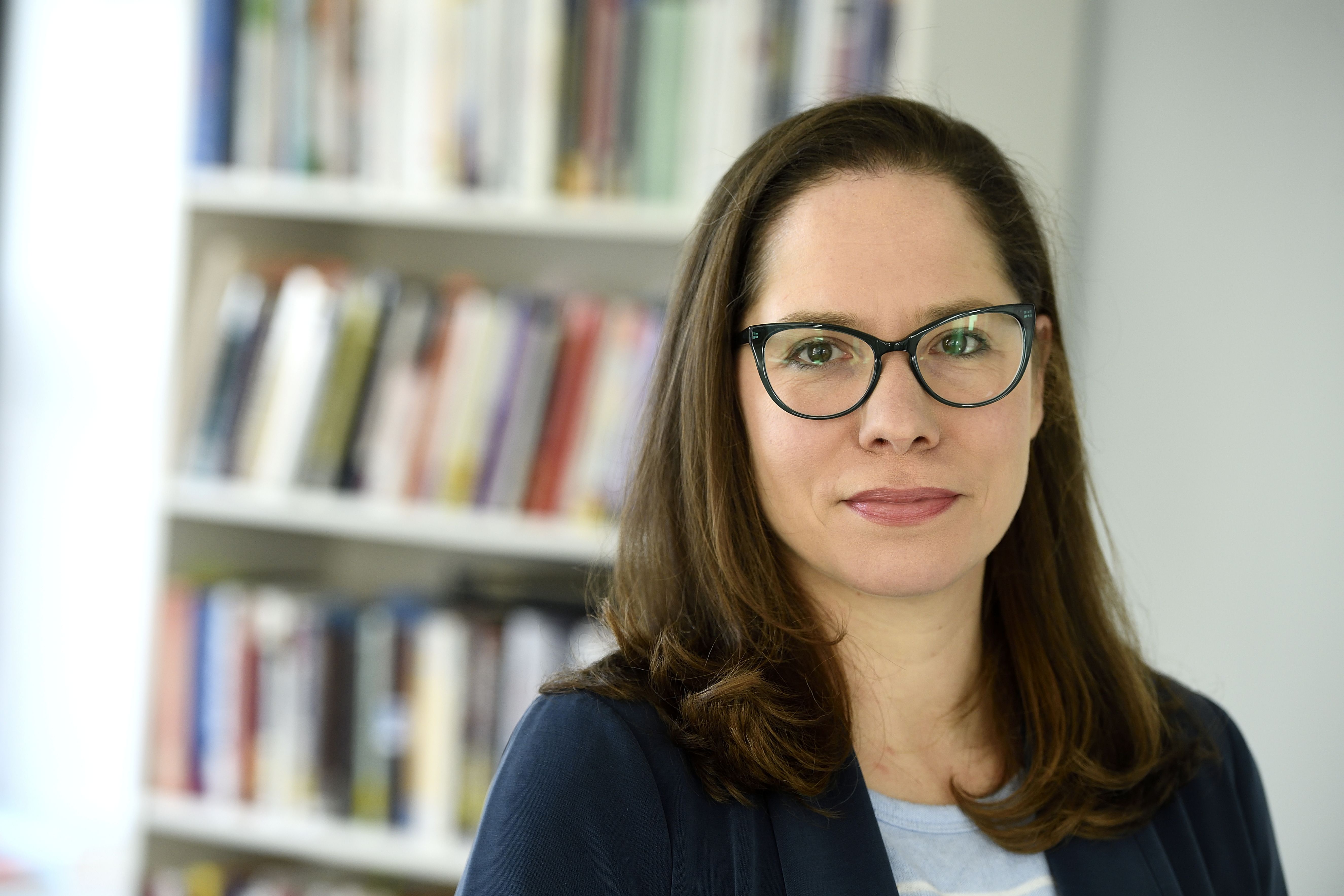 Portrait of Lilliana Mason with a bookshelf in the background; Political Polarization and the U.S. Midterms: In Conversation with Lilliana Mason
