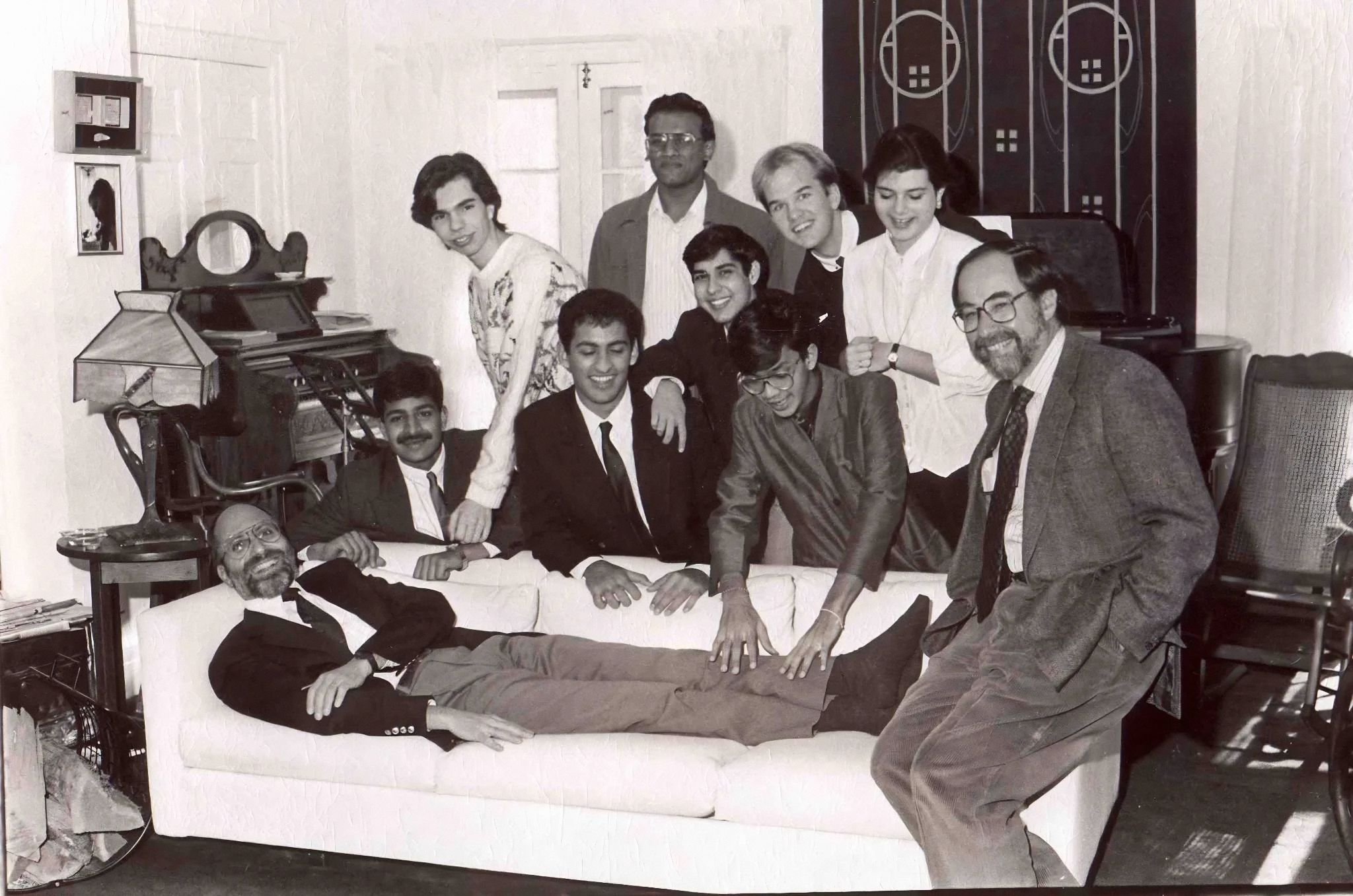 Professor Burt Brody (on couch) at Leon's, surrounded by students with Nobel Laureate biologist, David Baltimore (perched on arm of couch). Photo courtesy of former student, Manish Desai.&nbsp;<br />
<br />
If you are in this photo, please let us know. We would love to identify everyone.&nbsp;<br />
<br />
This past Sunday, April 27, alumni/ae, friends, family and staff from across the country and Europe attended the interment of Professor Emeritus of Physics, Burt Brody, at the Bard Cemetery. Many stories were shared of the lasting impact Burt had on their lives.