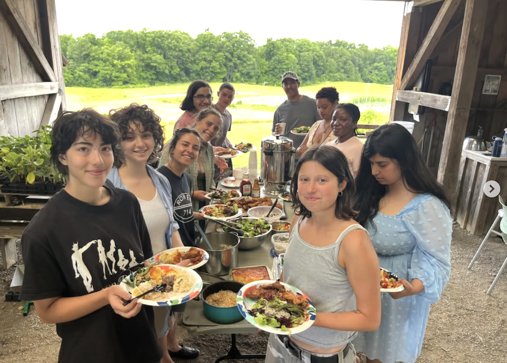 Bard students and community members enjoying a Bard Farm summer potluck. The Bard Farm Stand is open on campus every Thursday from 12pm-5pm through October.&nbsp;