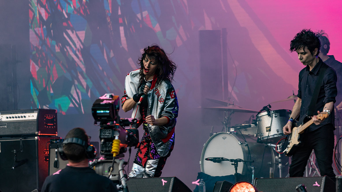 two musicians play instuments on stage at a rock concert