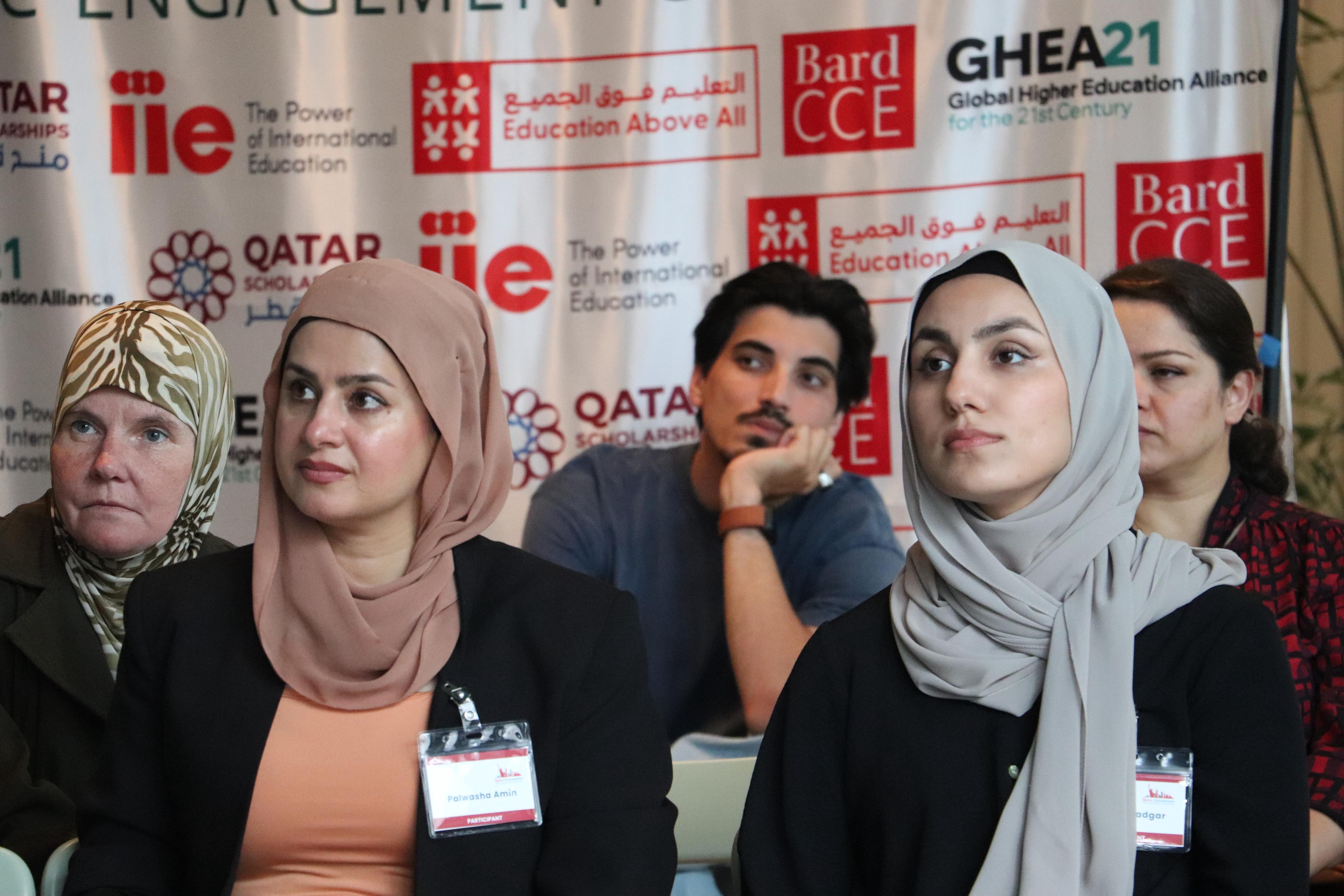 Six conference attendees listening