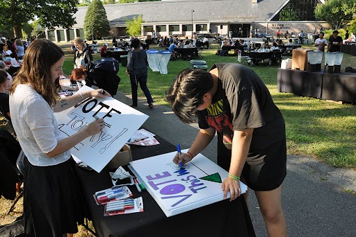 Students making signs at a polling location on campus