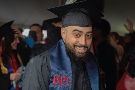 Jamal Armstead dressed graduating cap and gown.