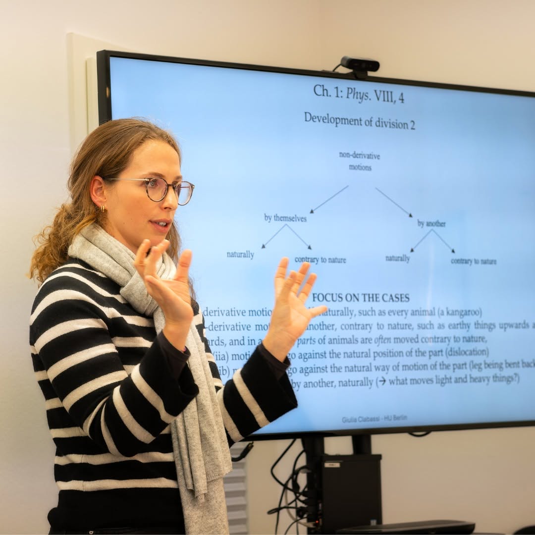 Guilia&nbsp;Clabassi&nbsp;gestures as she presents her dissertation in front of a screen&nbsp;