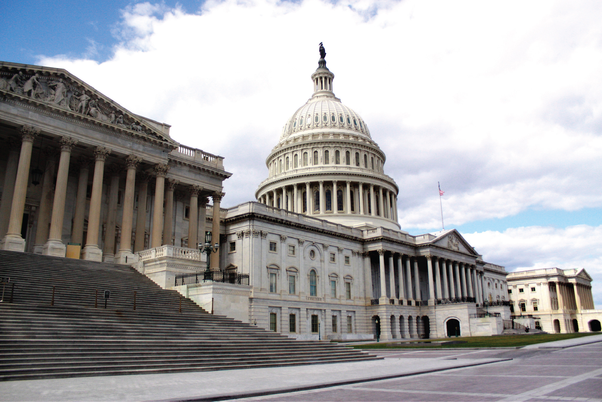 The facade of the U.S. Capitol building on a sunny day.