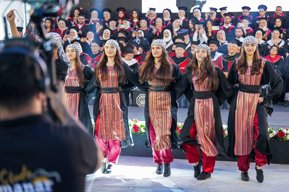 Dancers perform in front of graduating students from Al-Quds University.
