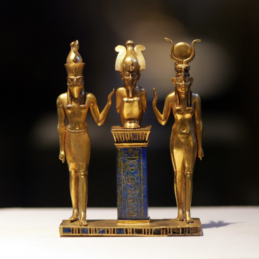 Triad of Osiris, Horus, and Isis. From Egypt, probably Thebes, Karnak Temple. Third Intermediate Period, Dynasty 22, reign of Osorkon II (about 872&ndash;837 BCE). Gold inlaid with lapis lazuli. Acquired in 1872. Paris, Louvre Museum, Department of Egyptian Antiquities (E 6204).
