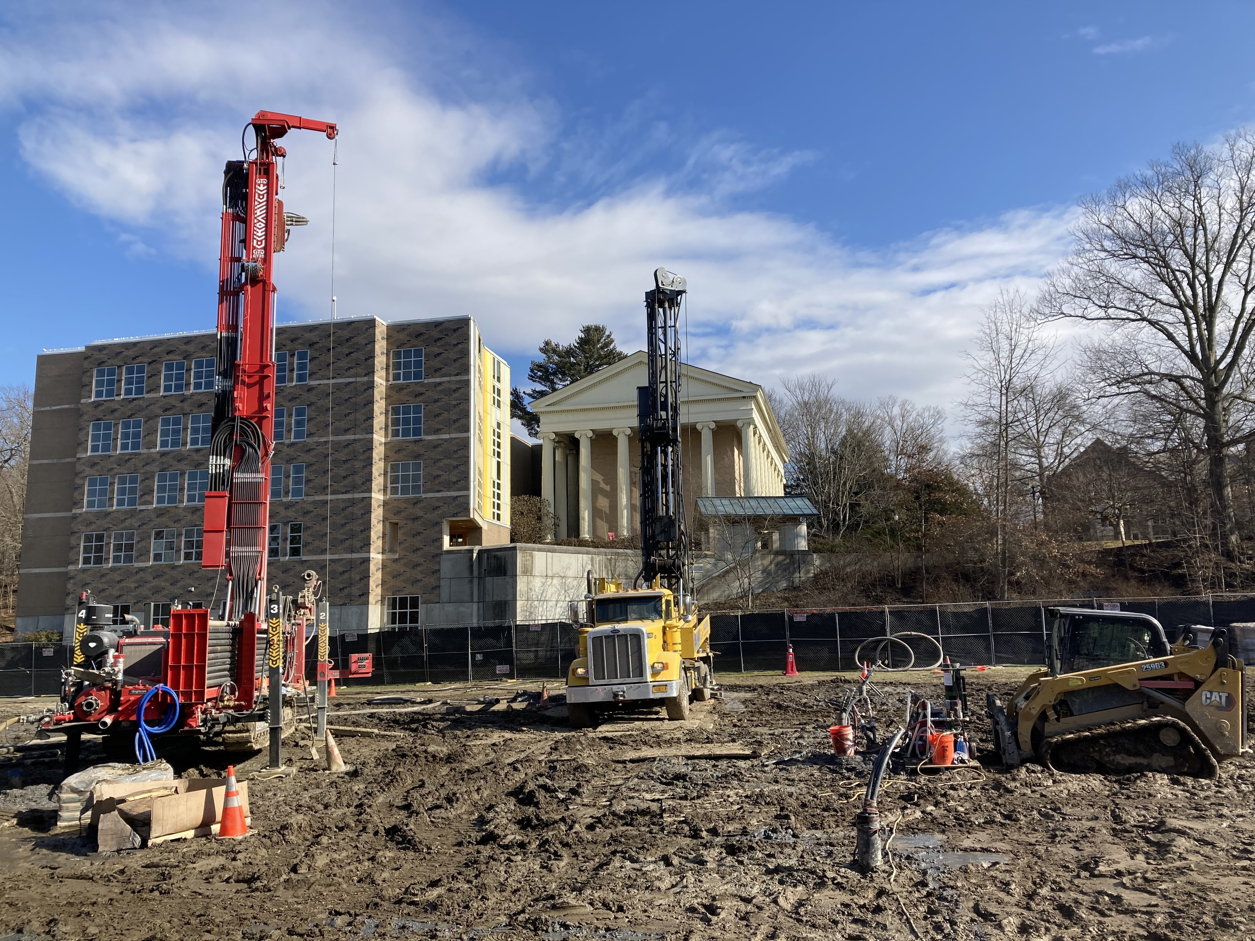 A crane and construction equipment in a bare lot.; Geothermal Systems at Bard College