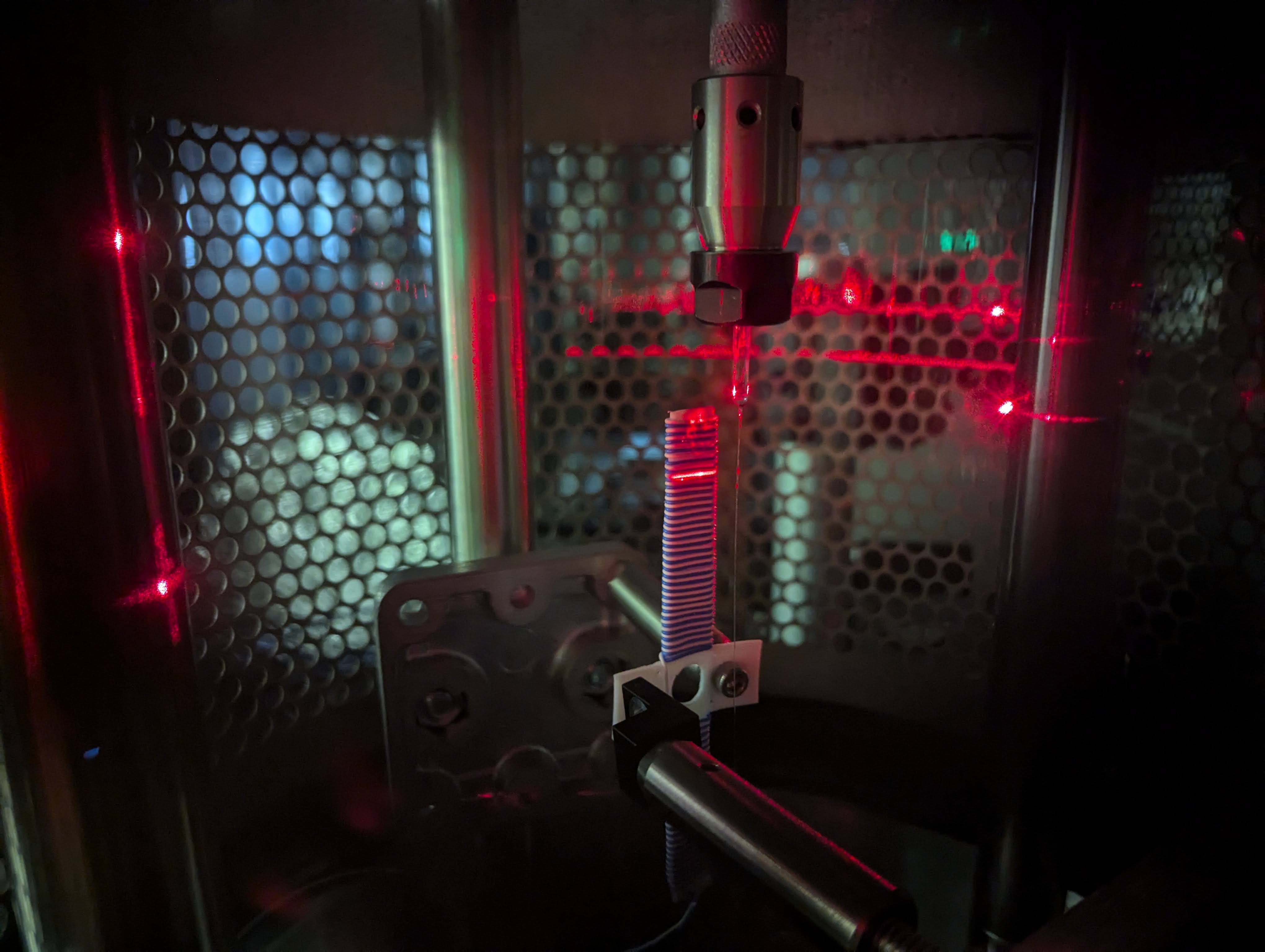 A partition in a lab with red lights lit up.; Detecting Gravitational-waves: From Instrumentation to Compact Binaries