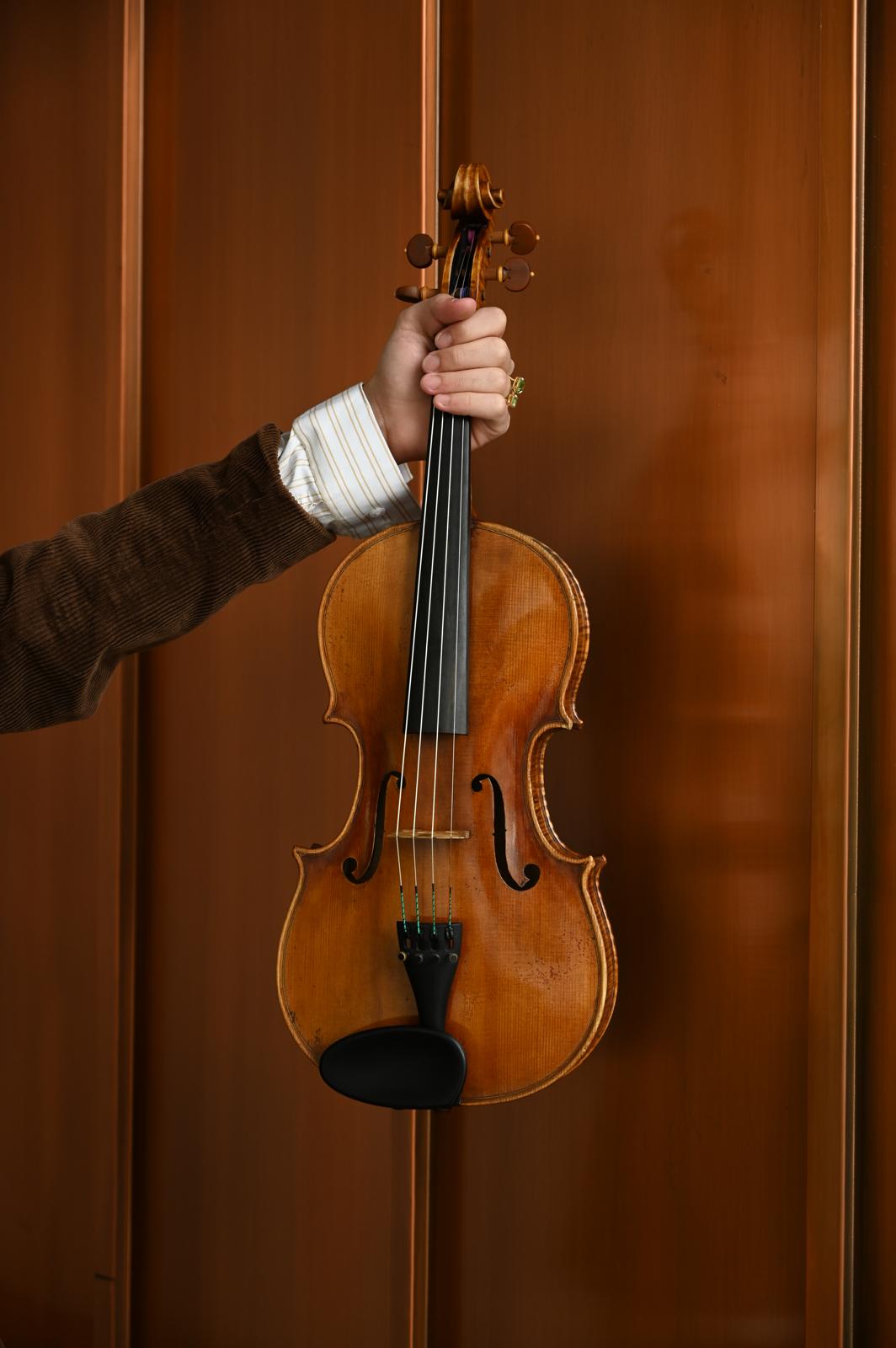 A hand holding a viola; Degree Recital:&nbsp;Guy Levy, viola