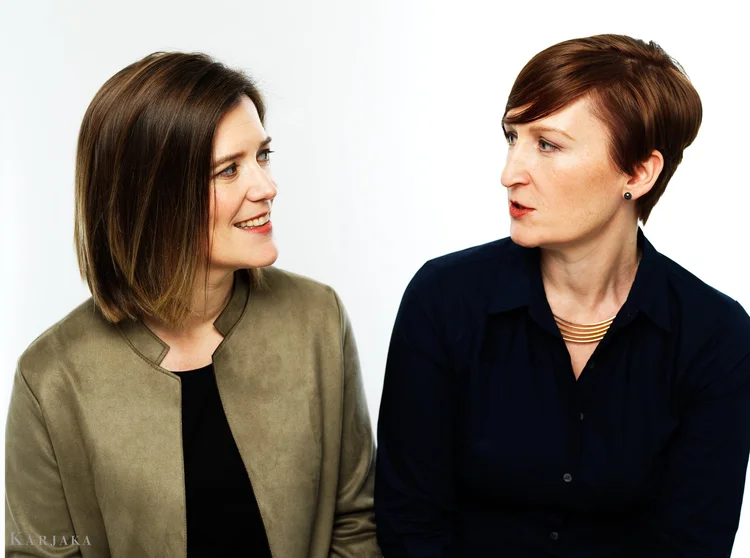 Erika Switzer (left) and Martha Guth (right) looking at each other, with a blank background.; Faculty Spotlight Series: Guest Artist Martha Guth, soprano, with Erika Switzer, piano; featuring Raman Ramakrishnan, cello