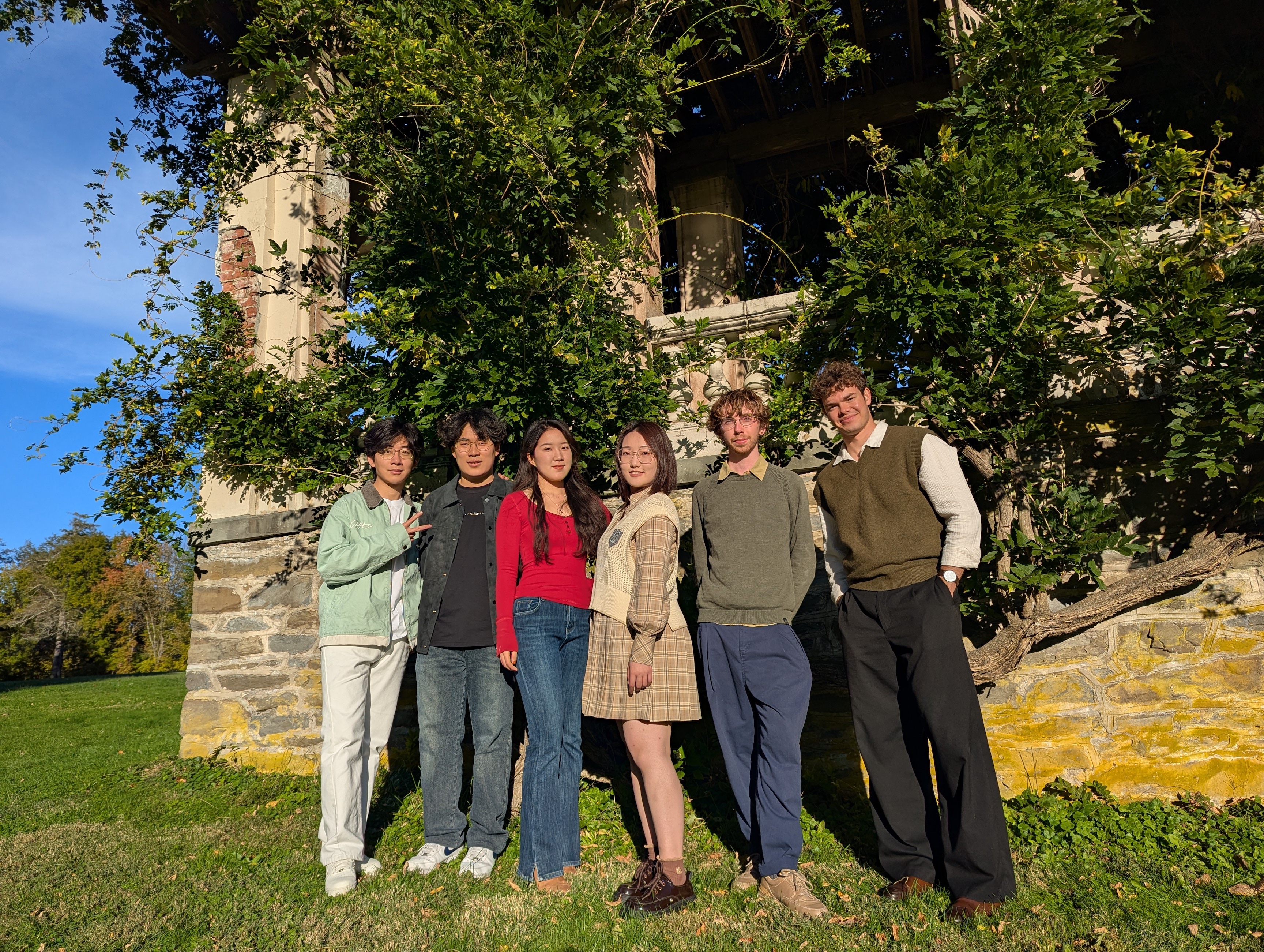 The piano students of Terrence Wilson standing in a line against a stone wall with greenery.; Studio Recital: Piano Students of Terrence Wilson&nbsp;