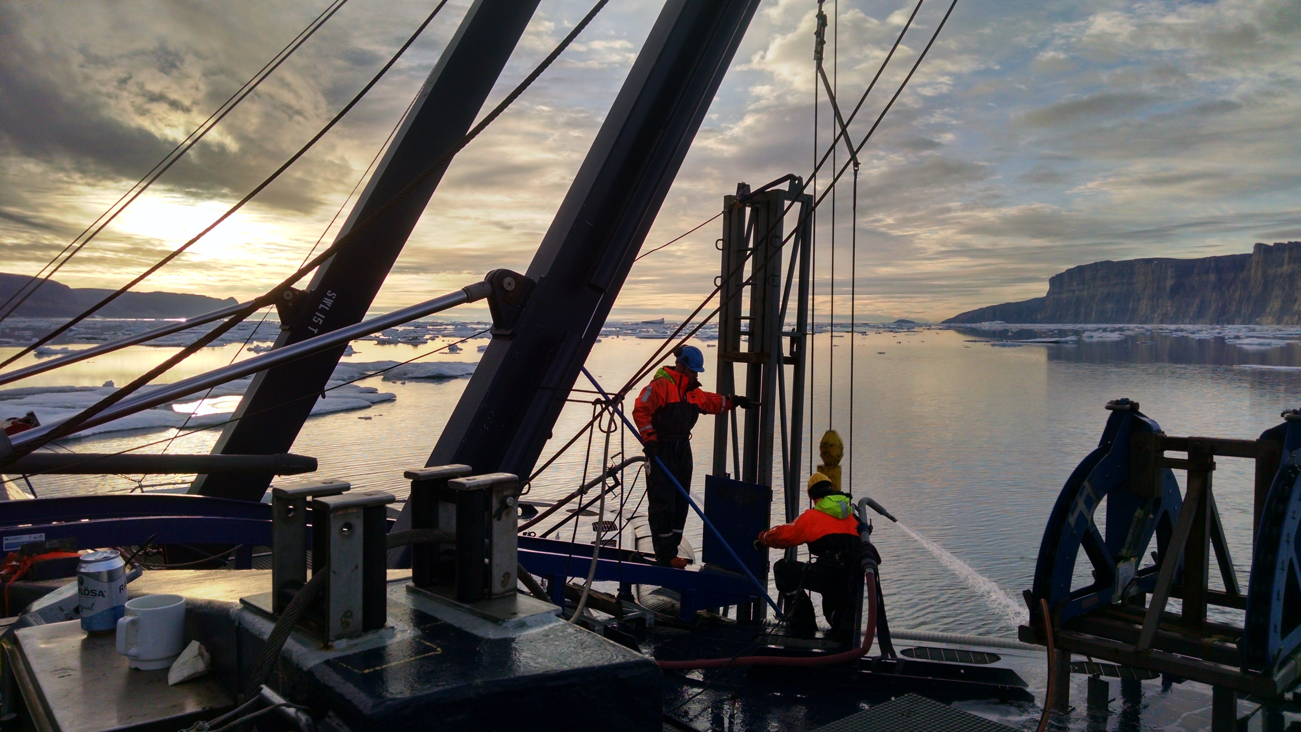 Dock workers on a boat.; Unlocking Ice Sheet Histories with Magnetic Stratigraphy